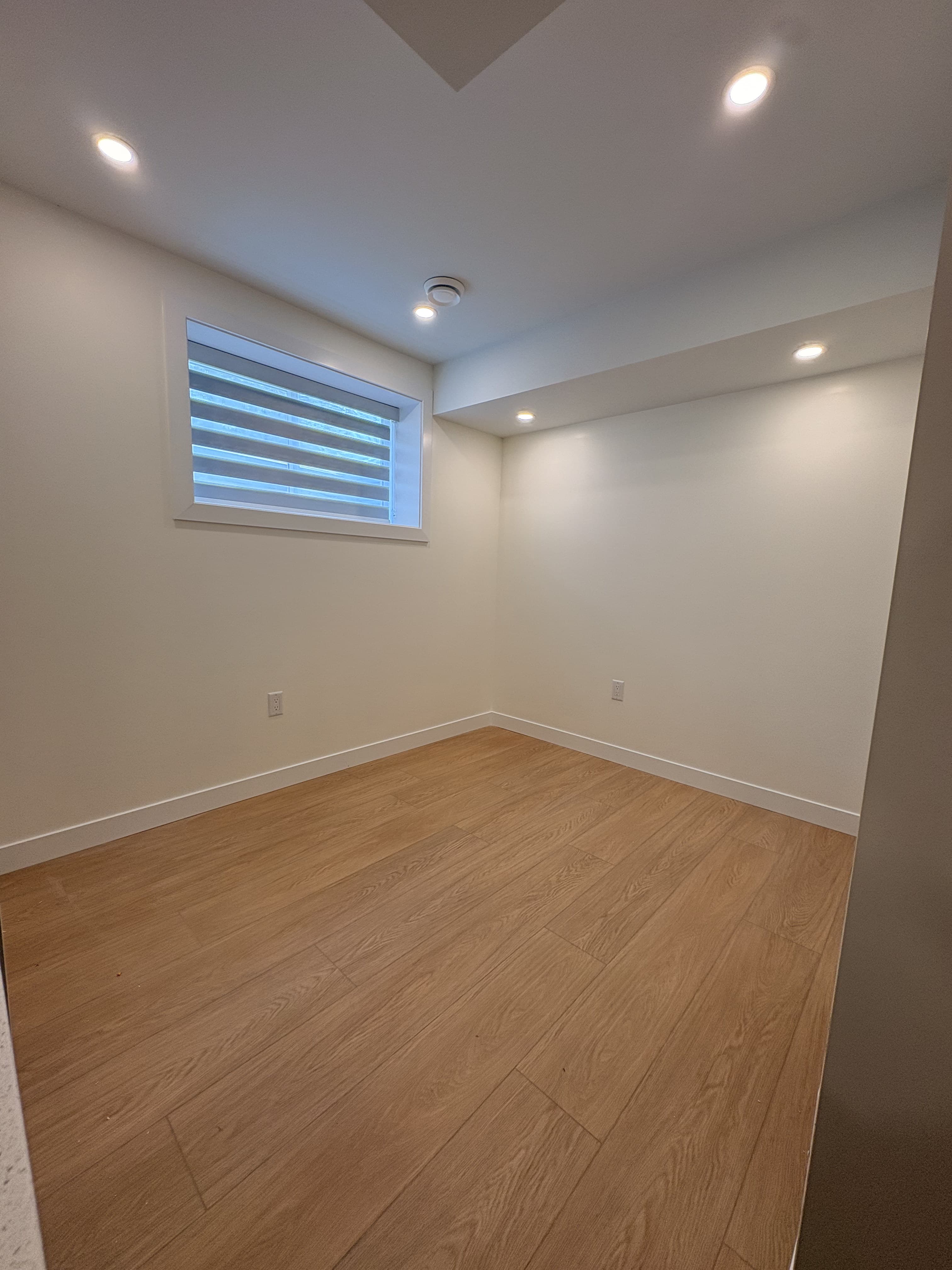 Finished legal suite bedroom with code-compliant egress window
